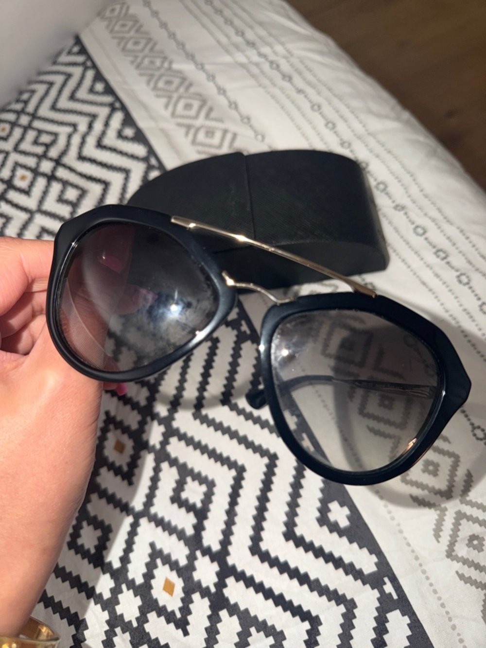 Prada Black Frame Sunglasses with Gold-Tone Bridge